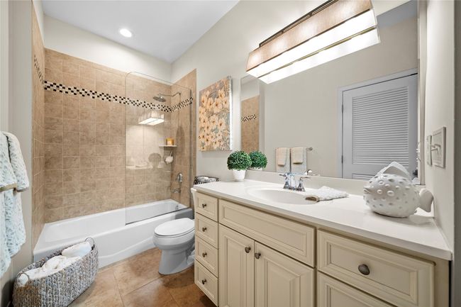 Bathroom featuring tile patterned flooring, vanity, toilet, and shower / bathing tub combination | Image 17