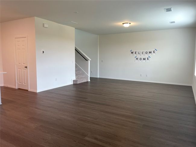 Family room with stairs, dark wood-type flooring, and baseboards | Image 11
