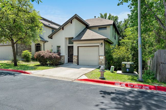The private driveway, attached garage, and shaded entry create a quiet, welcoming first impression that sets the tone for everything inside | Image 31
