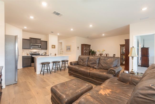 Living room featuring light wood-type flooring and recessed lighting | Image 17