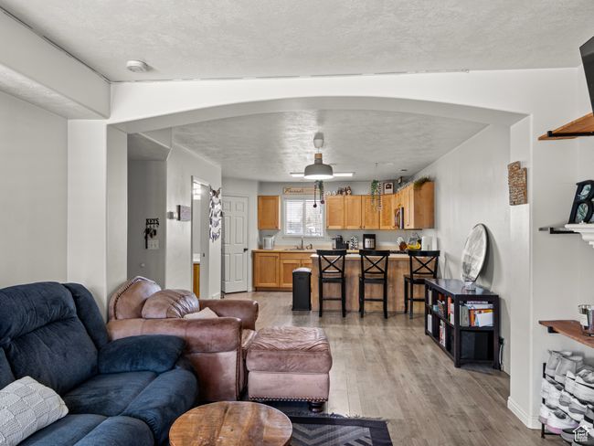 Living room with light hardwood / wood-style floors and sink | Image 5