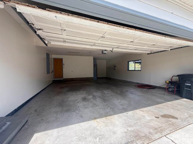 Garage with a garage door opener and electric panel | Image 32
