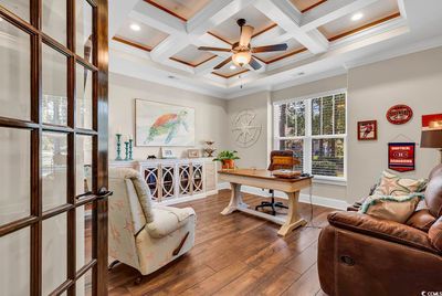 Office space with coffered ceiling, beamed ceiling, dark hardwood / wood-style floors, and crown molding | Image 3