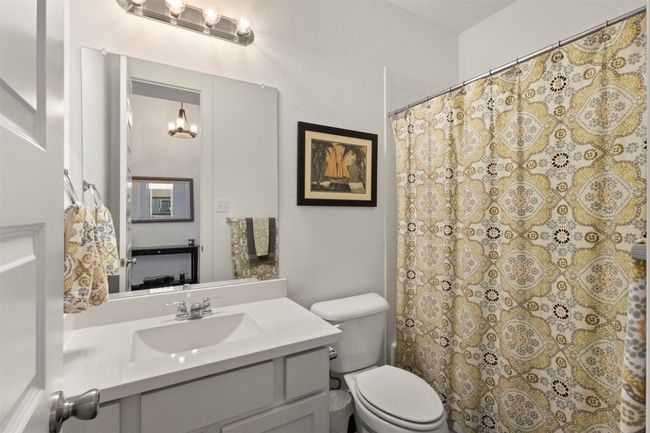 2nd Bathroom with vanity, a chandelier, and curtained shower | Image 11