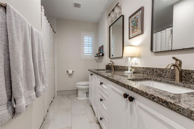 Secondary full bathroom with double sinks and granite counter. Shower-tub combo. Excellent condition! | Image 19
