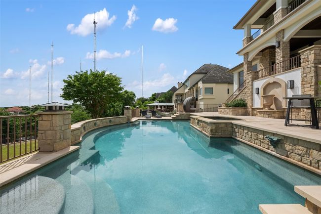 View of swimming pool with a pool with connected hot tub | Image 25
