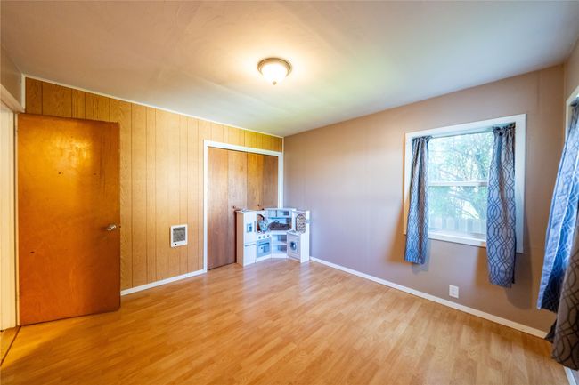 Empty room featuring wood finished floors, baseboards, and heating unit | Image 14