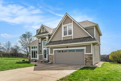 Craftsman-style home with a front yard and a garage | Image 2