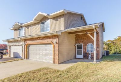 View of front facade with a front lawn, and a garage | Image 2