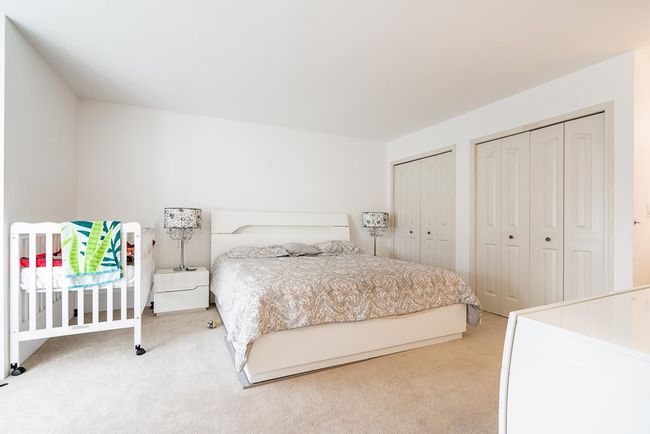 Bedroom with two closets and light colored carpet | Image 11