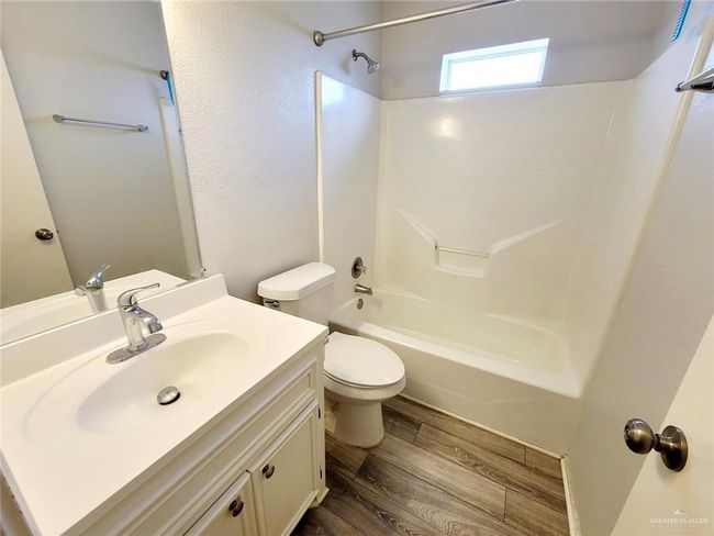 Full bathroom with vanity, shower / washtub combination, and wood finished floors | Image 18