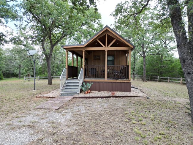 Rustic home featuring a porch | Image 12