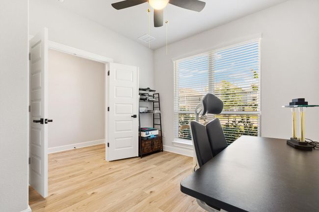 Office featuring ceiling fan, light wood-style flooring, and baseboards | Image 16