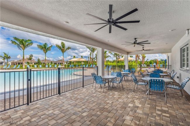 View of patio / terrace with a community pool and ceiling fan | Image 13