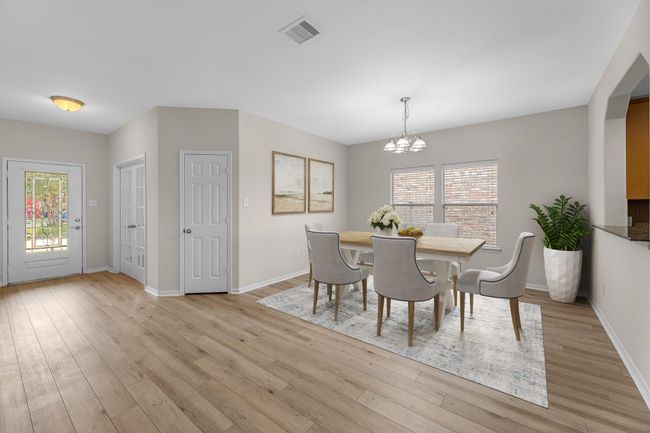 View of the entry and formal dining room. The dining area is a perfect blend of style and functionality, providing an inviting space for memorable meals and gatherings. Virtually staged to show furniture placement. | Image 6