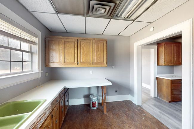 Kitchen featuring sink, a drop ceiling, and dark hardwood / wood-style floors | Image 24