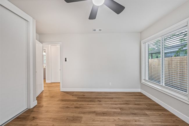 Empty room featuring ceiling fan and wood finished floors | Image 12