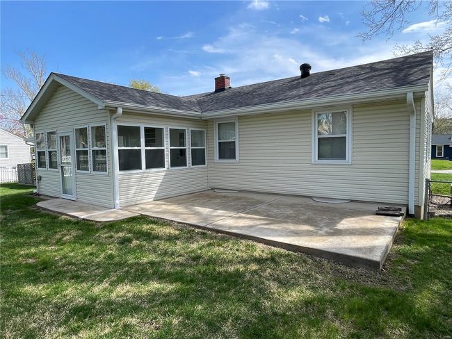 Rear view of house featuring roof with shingles, a yard, and a patio | Image 45