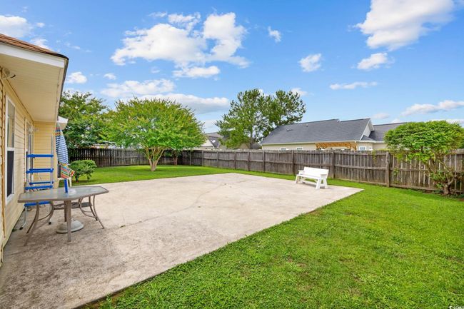 Fenced backyard featuring a patio area | Image 15