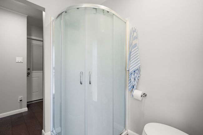 Full bath with toilet, a stall shower, and wood finished floors | Image 23