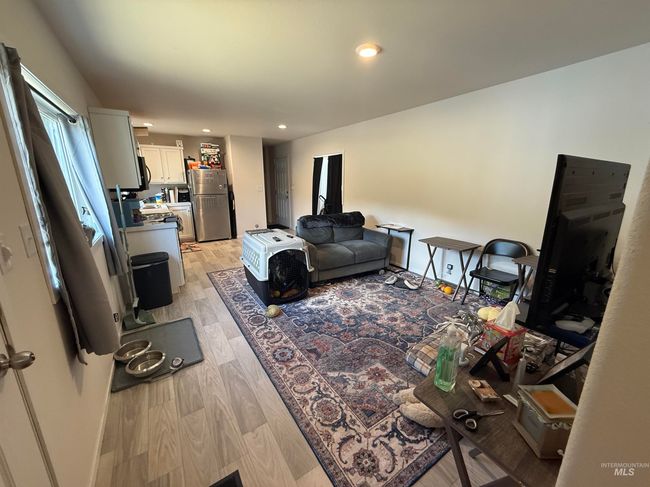 Living room with light wood-style flooring and recessed lighting | Image 4