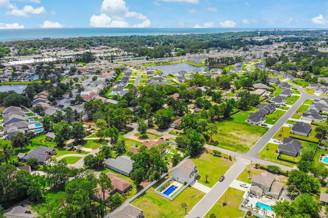 Aerial view of residential area featuring a nearby body of water | Image 36