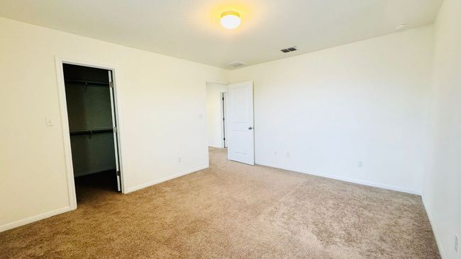Unfurnished bedroom with carpet floors and a walk in closet | Image 34