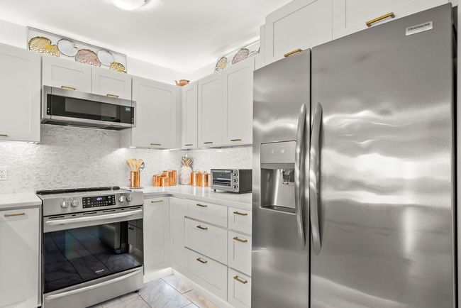 A ton of upgraded lighting throught the kitchen, plus Frigidaire and whirlpool appliances. | Image 10