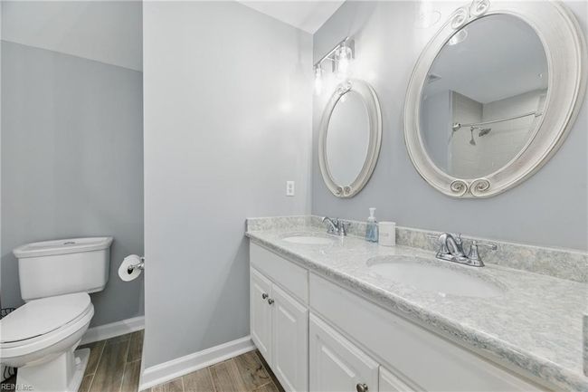 Updated Full Bathroom 2 sits just off the main hallway of the 2nd floor and boasts dual sinks, quartz countertops, and bathtub/shower combo... | Image 25