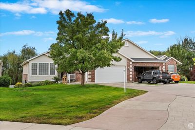 View of front facade featuring a front lawn and a garage | Image 2