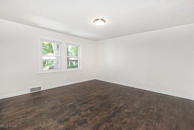 Spare room with hardwood / wood-style floors and crown molding | Image 21