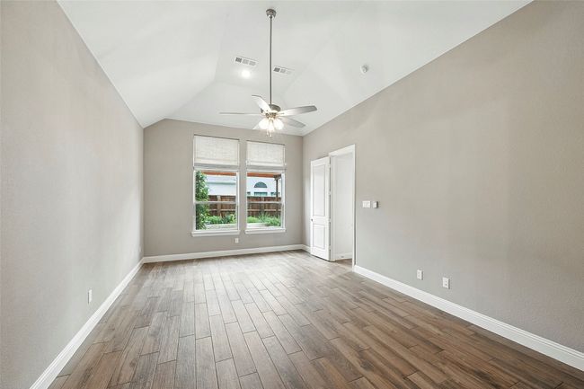 Spare room with tile floors, vaulted ceiling, and a ceiling fan | Image 18