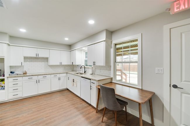 Kitchen featuring a sink, light wood-style floors, white cabinetry, and dishwasher | Image 11
