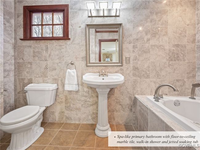 Spa-like primary bathroom with floor-to-ceiling marble tile, walk-in shower and jetted soaking tub | Image 29