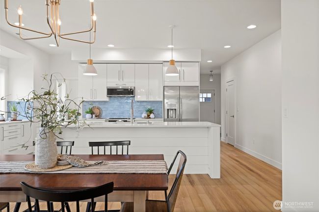 Looking toward the front entry with the powder room on the right beyond the kitchen. | Image 9