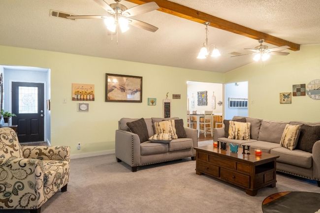 High ceilings with a wood beam for accent. | Image 9