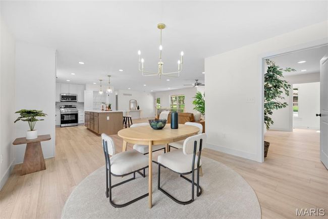 Dining space featuring a chandelier, ceiling fan, light wood-style floors, and recessed lighting | Image 22