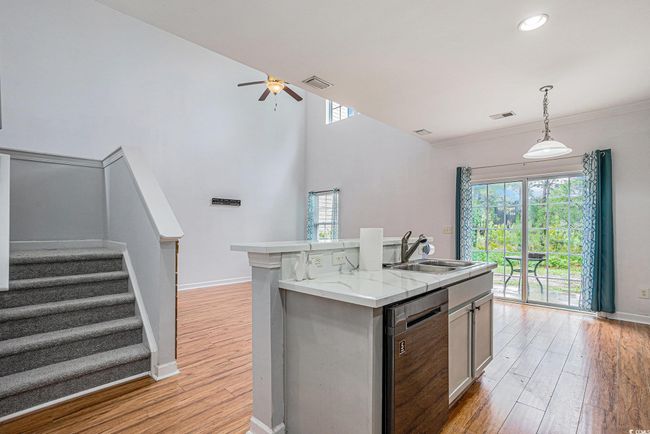 Kitchen with stainless steel dishwasher, light wood-type flooring, plenty of natural light, ceiling fan, and recessed lighting | Image 4