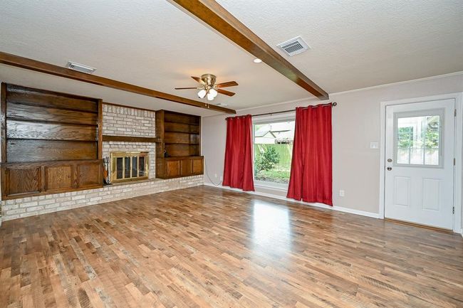 Living Room with recessed lighting and cozy fireplace. | Image 16