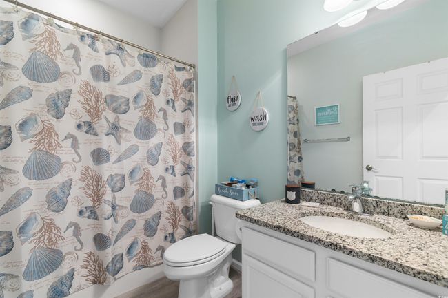 Full bath with toilet, vanity, and a shower with curtain | Image 20