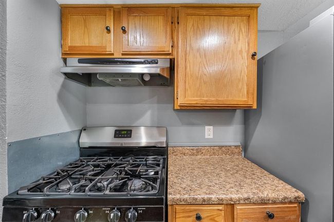 Kitchen with gas range. | Image 12