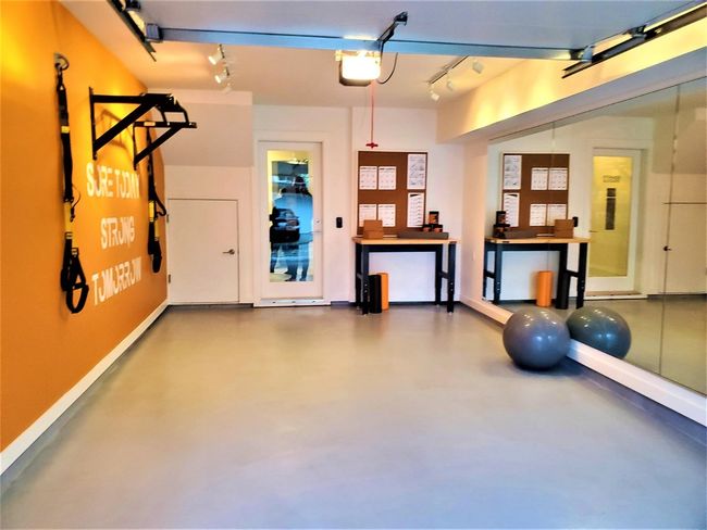 Garage featuring a garage door opener and baseboards | Image 4