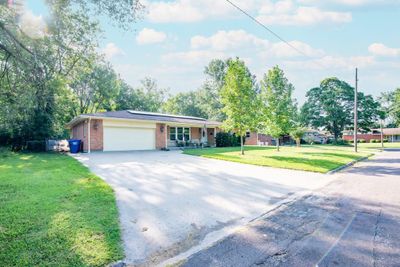 Single story home with a garage and a front lawn | Image 1