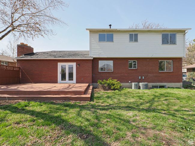 Back of property featuring a wooden deck, brick siding, and french doors | Image 14