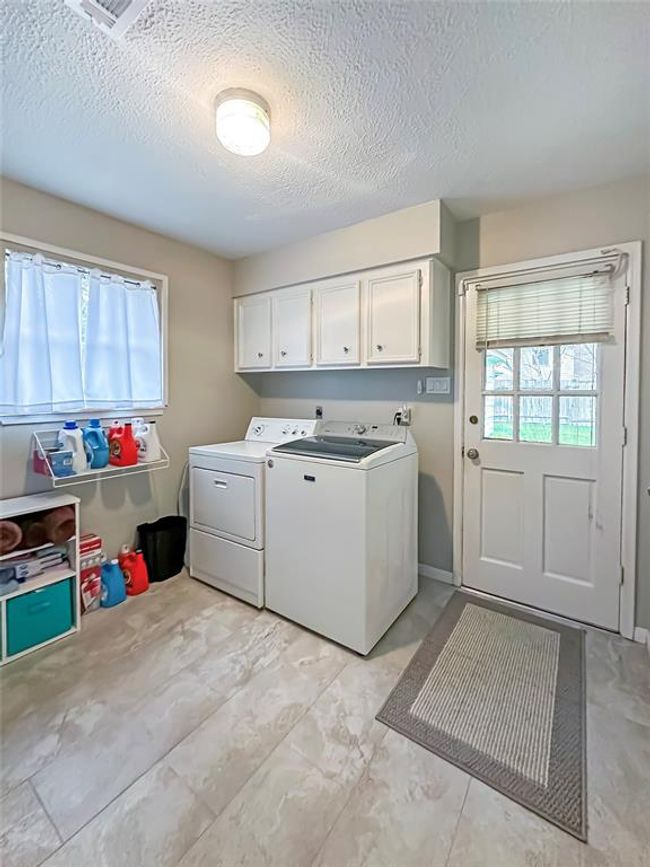 Laundry room leads to back yard. | Image 25