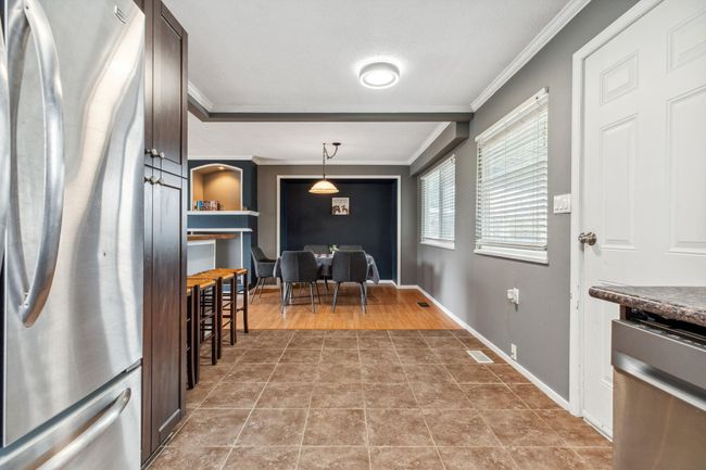 Interior space featuring ornamental molding, baseboards, visible vents, and light tile patterned floors | Image 16