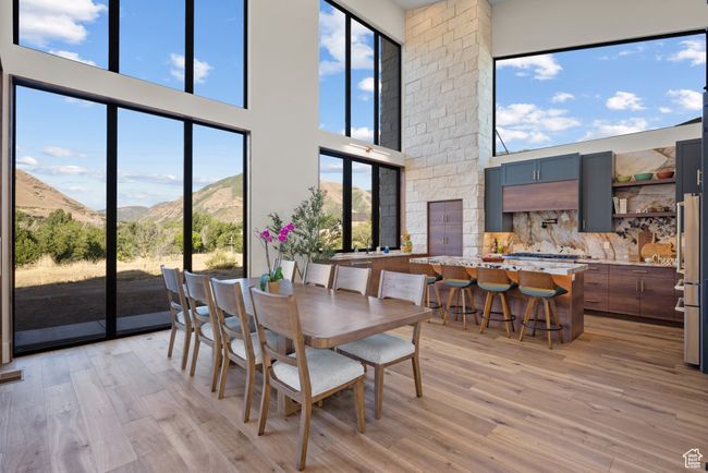 Dining room featuring a mountain view, a high ceiling, and light wood-type flooring | Image 23