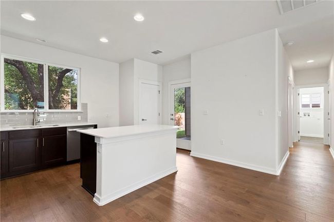 Kitchen with dishwasher, wood finished floors, light countertops, and recessed lighting | Image 12