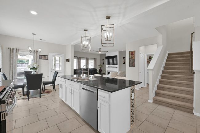 Enjoy an open floor plan where the kitchen, breakfast area, and living spaces flow together beautifully. You'll also benefit from the upgraded stove and dishwasher. | Image 10