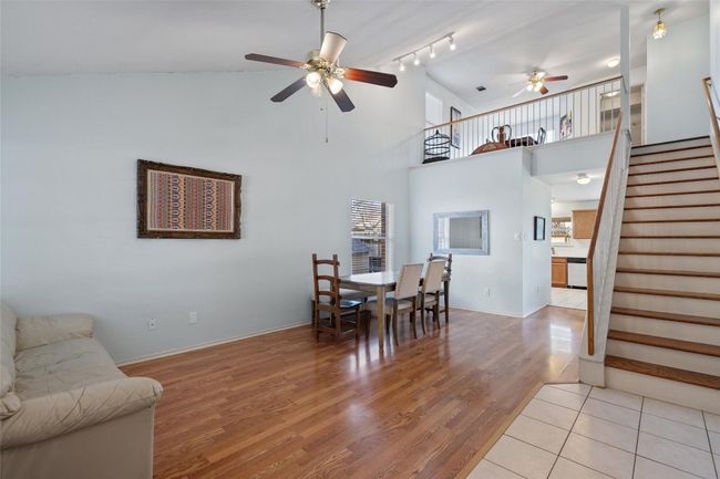 Dining room featuring ceiling fan, stairway, light wood-type flooring, and baseboards | Image 4
